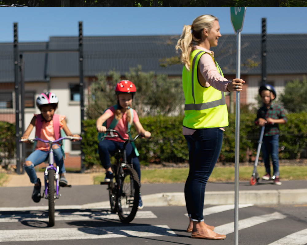 children cross street for school with cross guard