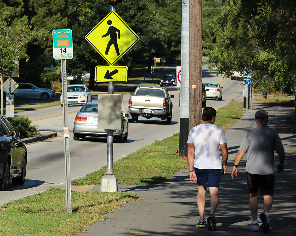 pedestrians on sidewalk near street