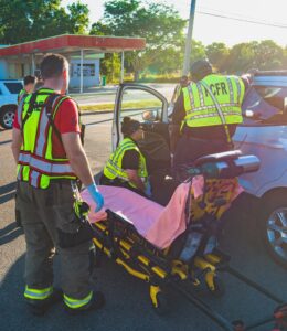 Polk County Fire Rescue paramedics assisting a crash victim on Polk County roads, demonstrating the importance of roadway safety and emergency response.