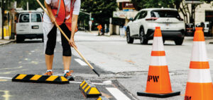 Painting roadway markings as part of a Vision Zero traffic safety demonstration.
